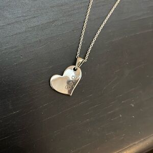 Necklace in silver color says Big Sis on front heart